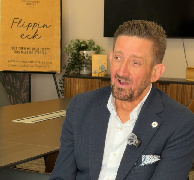 Wayne Topley sat in a conference room being interviewed.